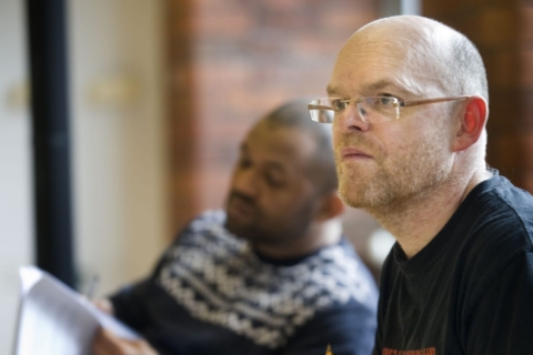 Two men in rehearsals with scripts of the play