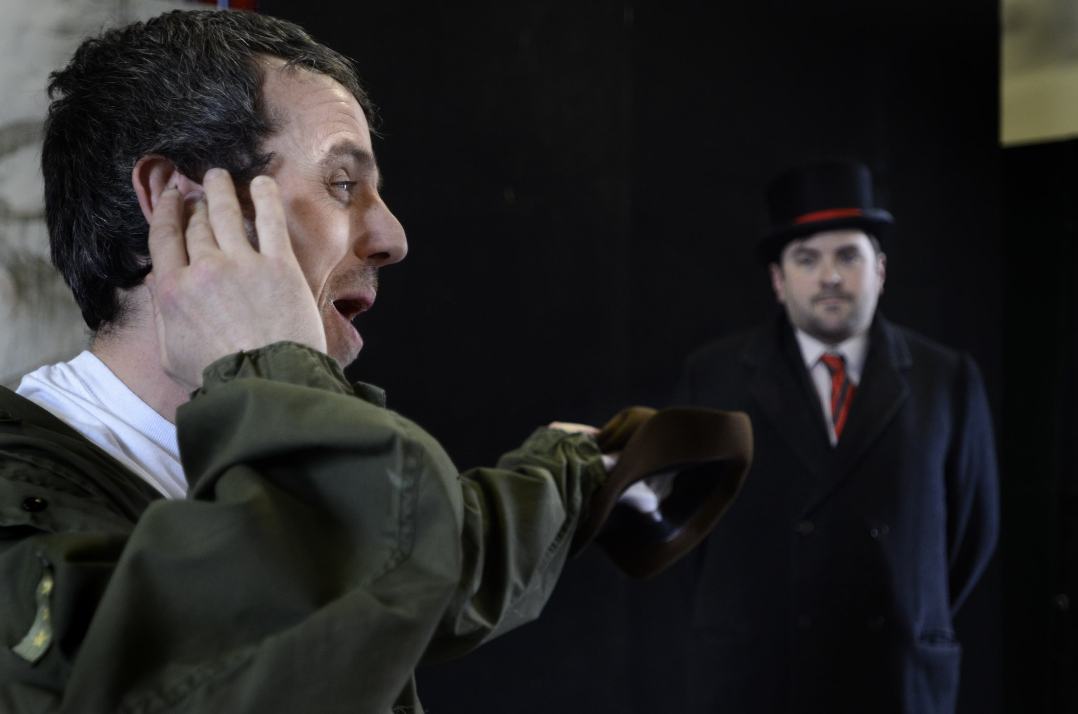 A distressed man in a parka pointing to a doorman