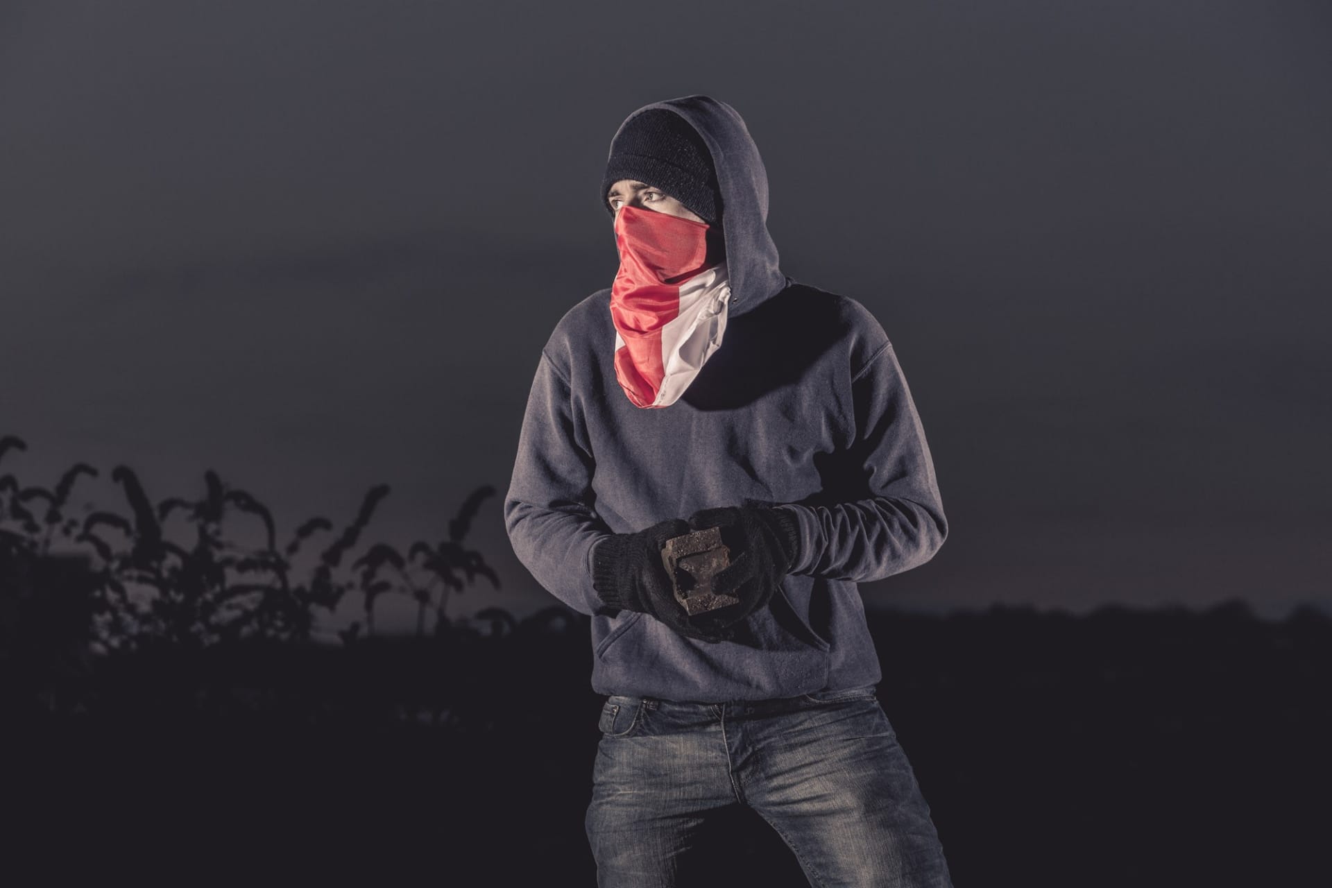 A man dressed in all black, with a balaclava