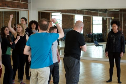 A group of actors in a rehearsal room