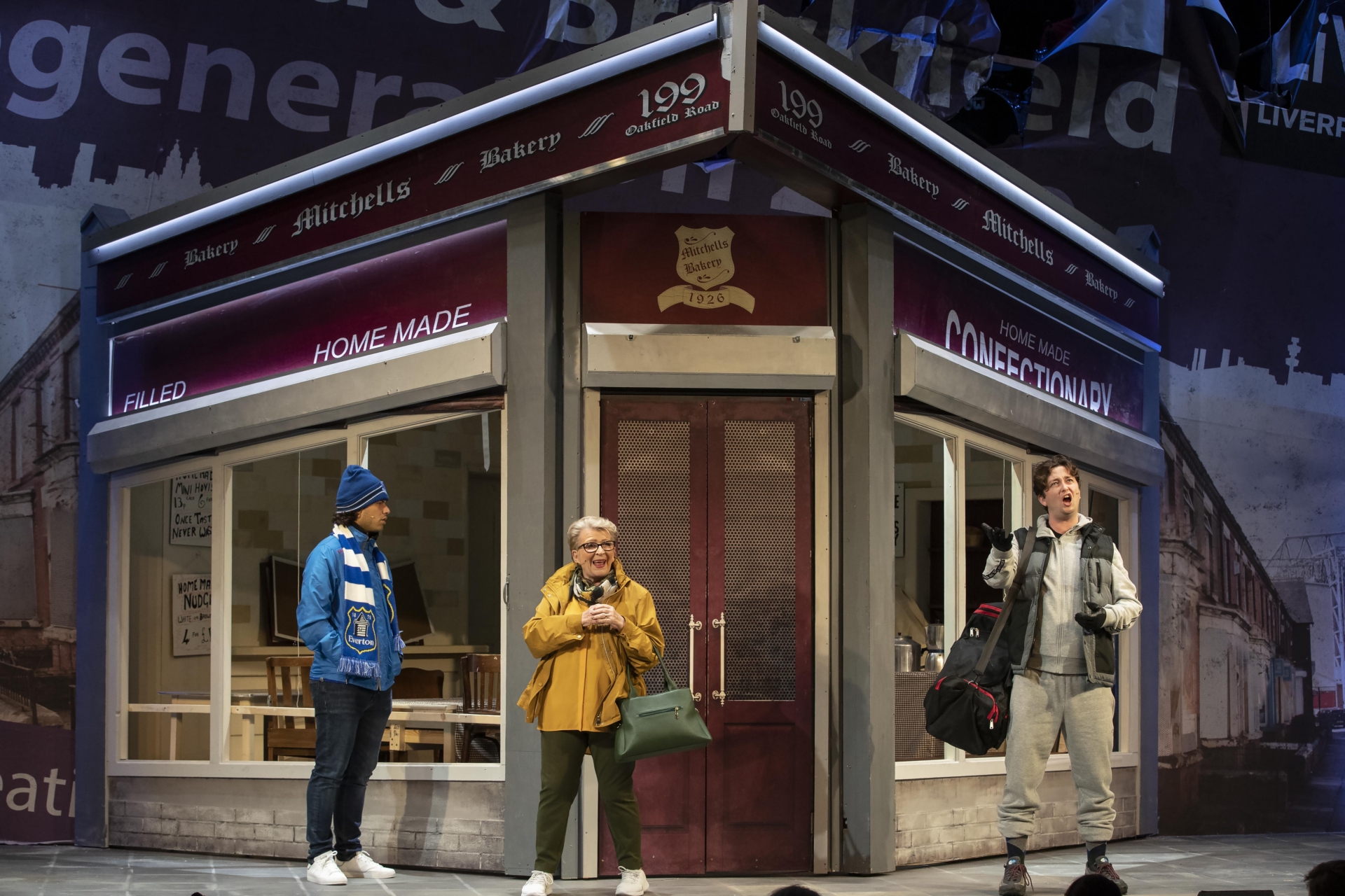 Three people stood outside a bakery.