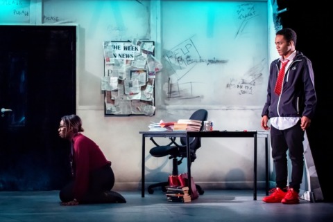 A teacher knelt on the floor in submission whilst her teenage pupil looks on shocked