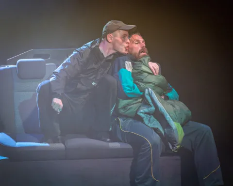 A man squished against a rough sleeper in the back of a cab threateningly