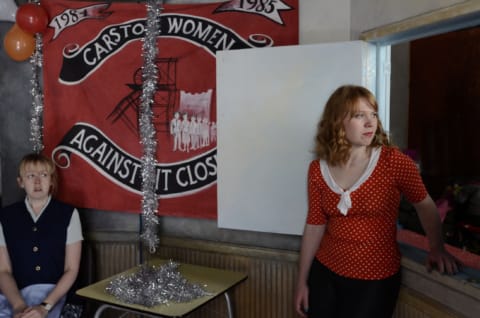 Two women stood infront of a 'Women Against Pit Closures' banner.