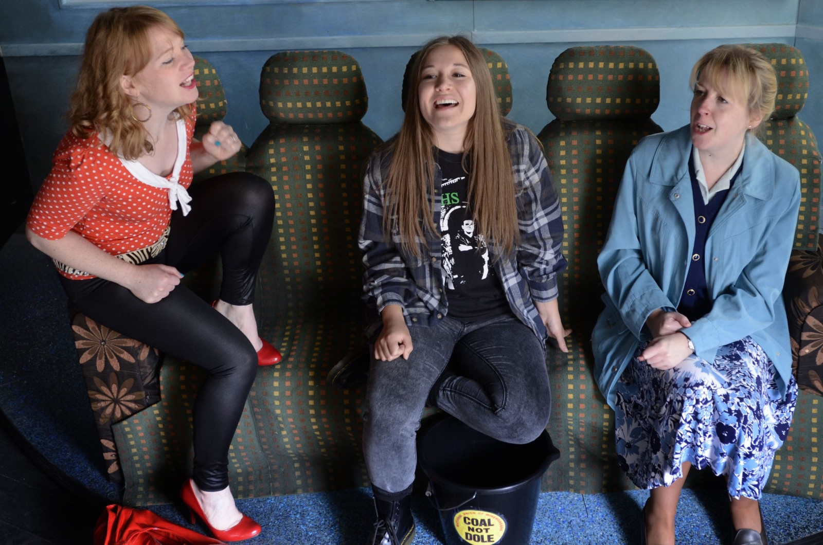 Three women laughing on a bus