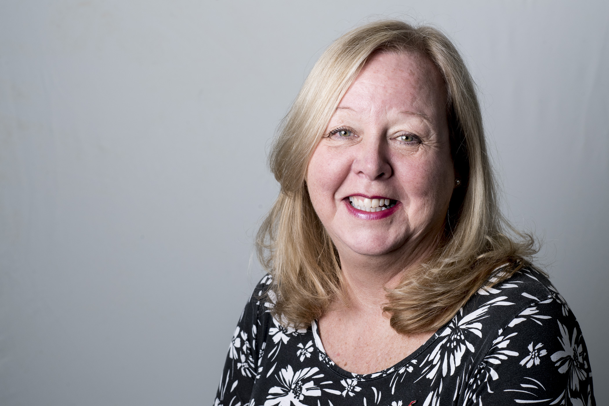 A smiling Karen Reay with shoulder length blonde hair