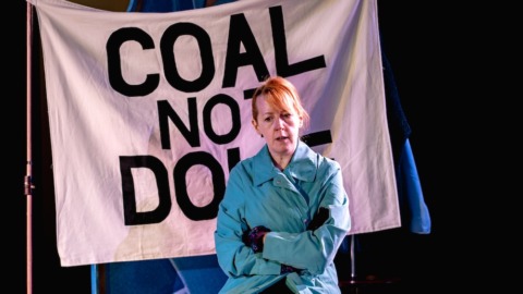 Olive sat on the picket line in coat and gloves looking worried