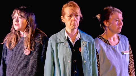 Three sisters stood with backs facing looking solemn