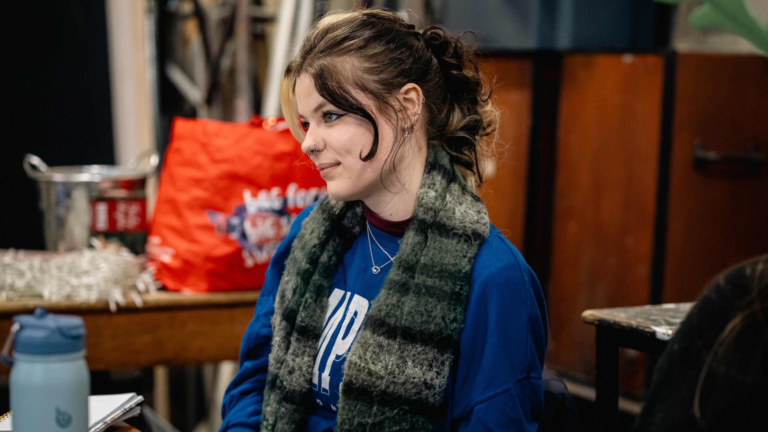 Lillie Rose with scarf on sat watching rehearsals