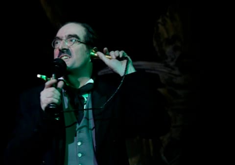 A man on an early 20th century telephone