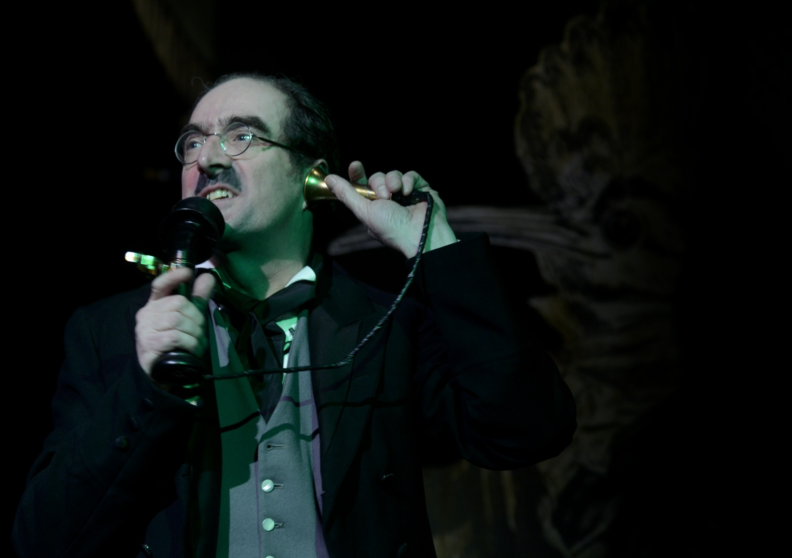 A man on an early 20th century telephone