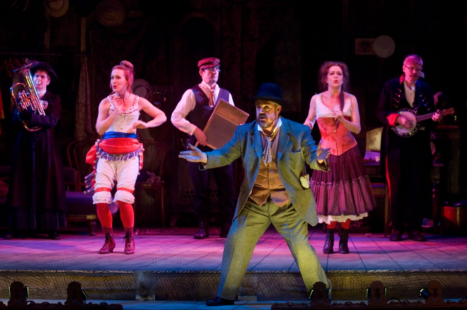 A group of music hall performers on stage