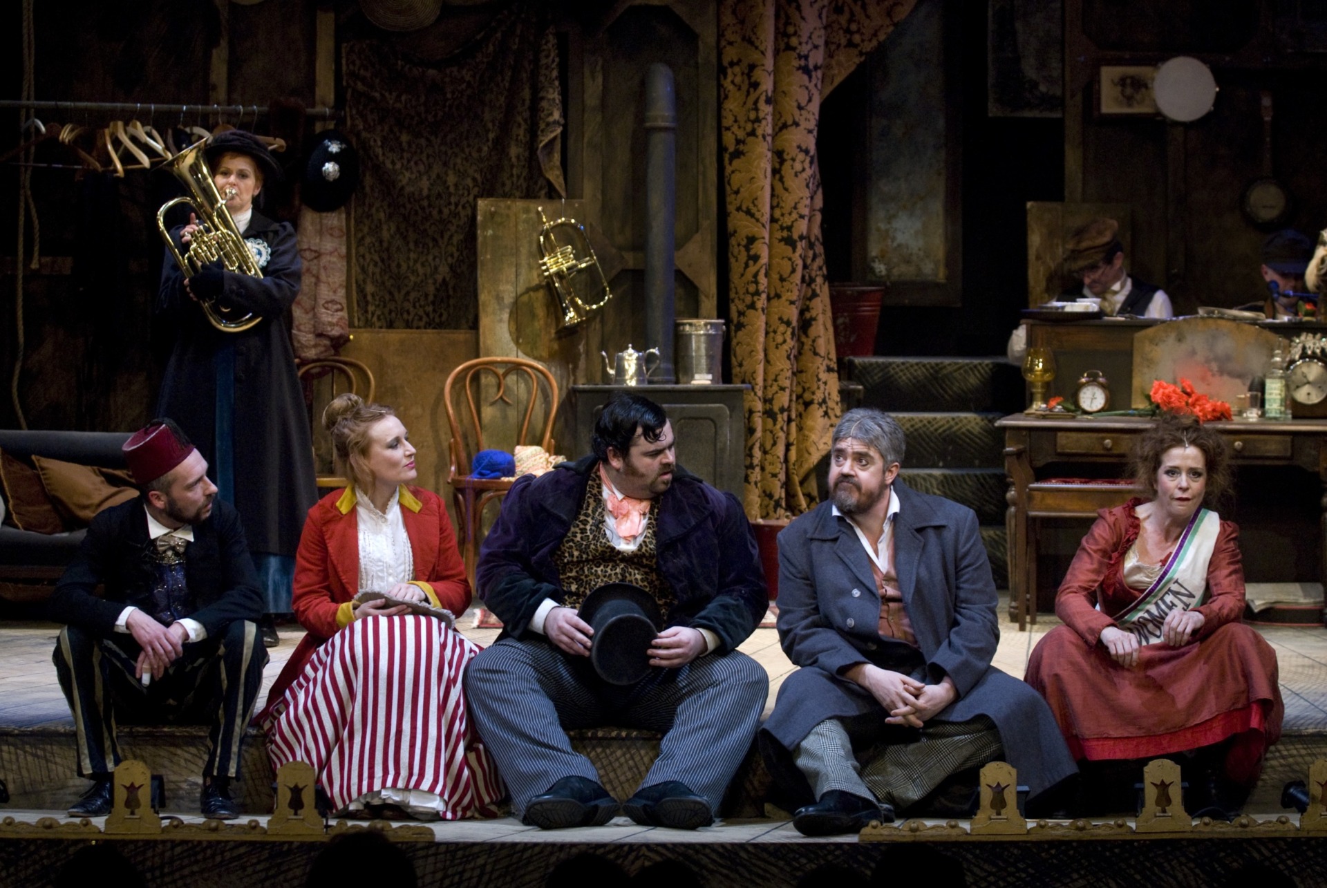 A group of music hall performers on stage