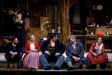 A group of music hall performers on stage