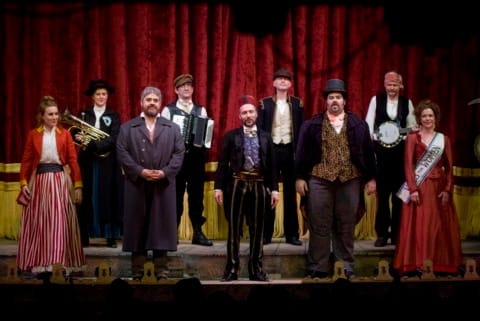 A group of music hall performers on stage