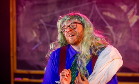 A man in a long wig looking dreamy