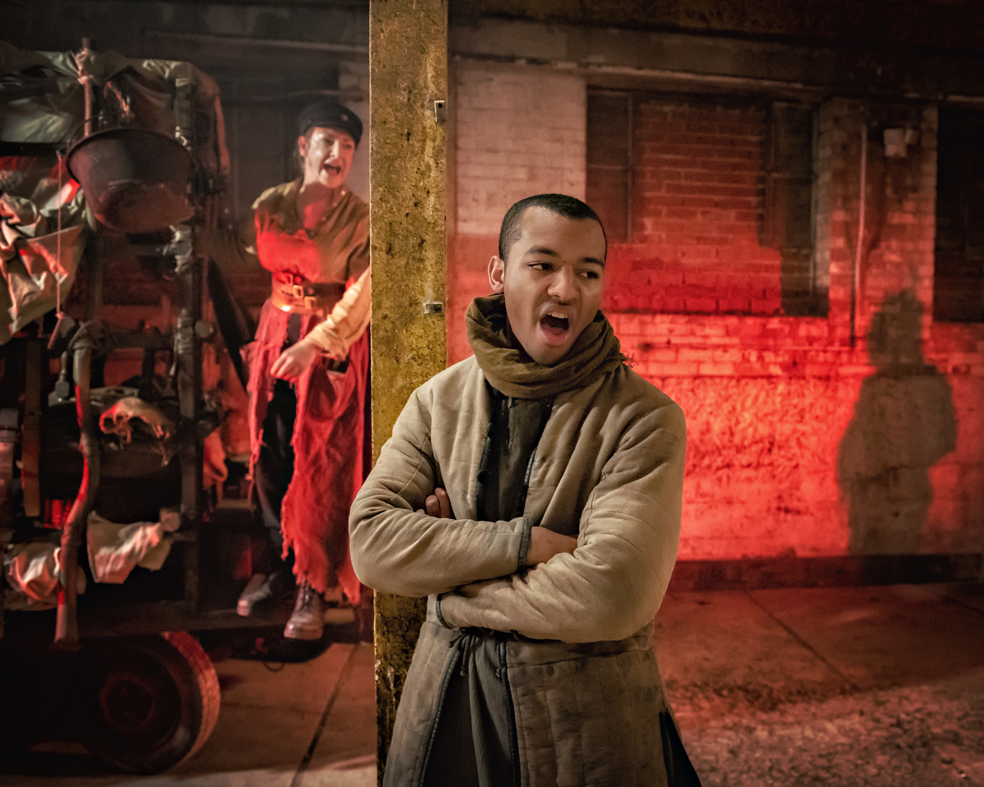 A mother in peasant's clothing watches her son