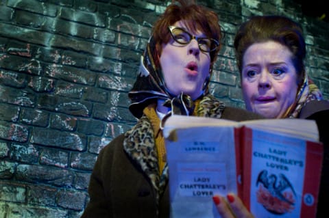 Two women in 50s head scarves reading Lady Chatterley's Lover. One is shocked and the other enthralled