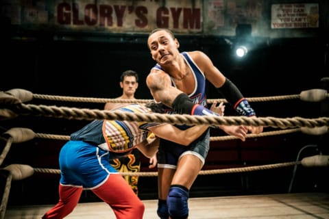 A wrestler reaching to grab another in a ring