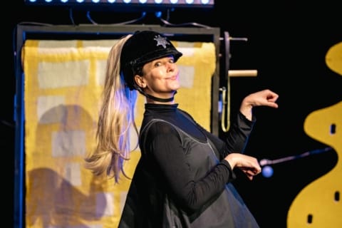 a woman in a riding hat prancing like a horse
