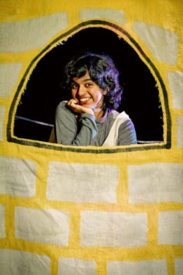 A girl in the window of a tower