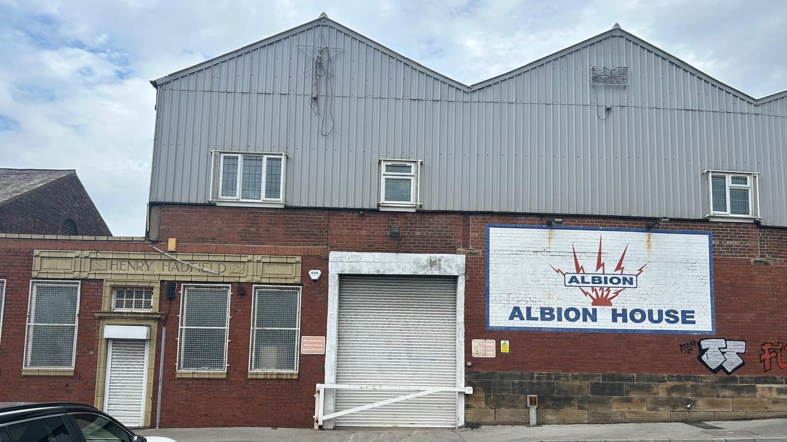The outside of a brick warehouse with Albion House sign on side