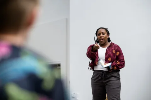 Alicia pointing a pen towards a member of the audience